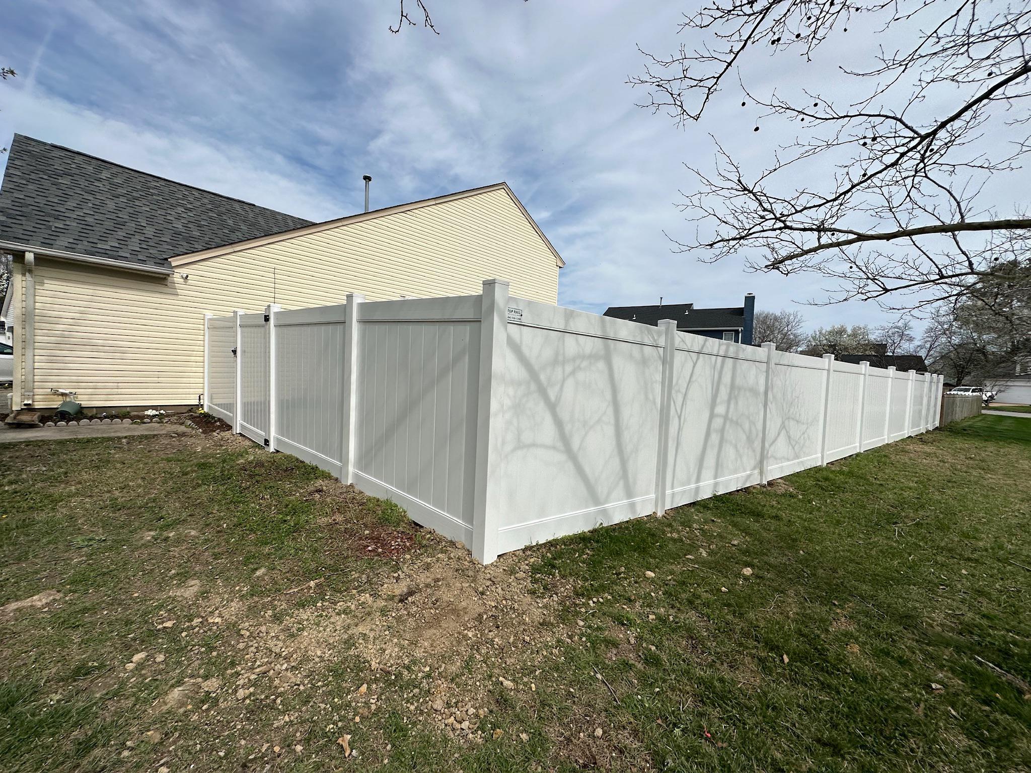 white vinyl fence installed by top rail fence