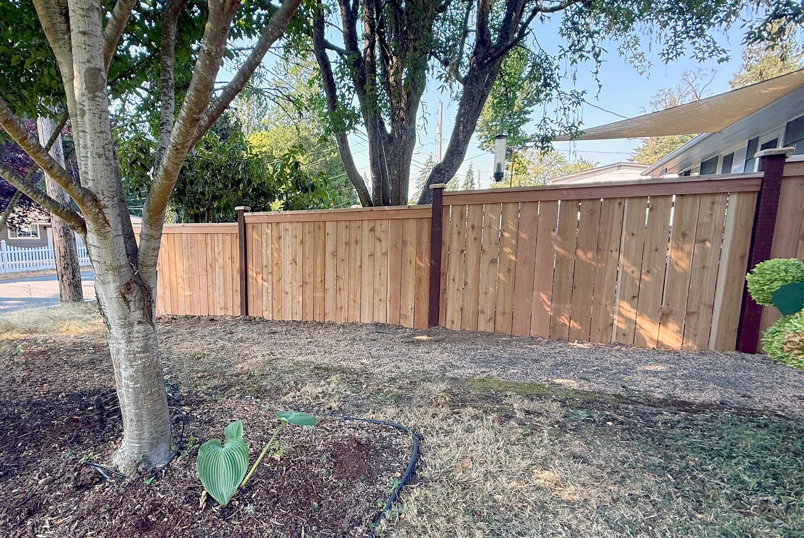 wood cap and trim fence installed by top rail fence