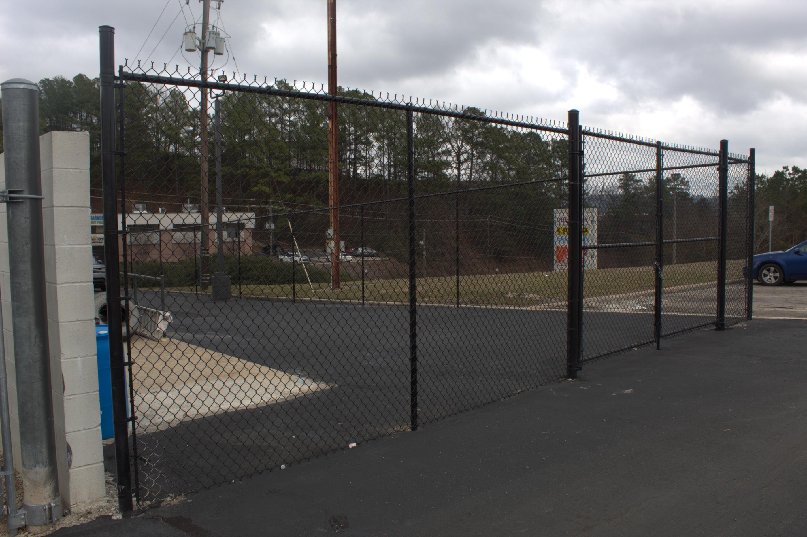 black chain link fence installed by top rail fence