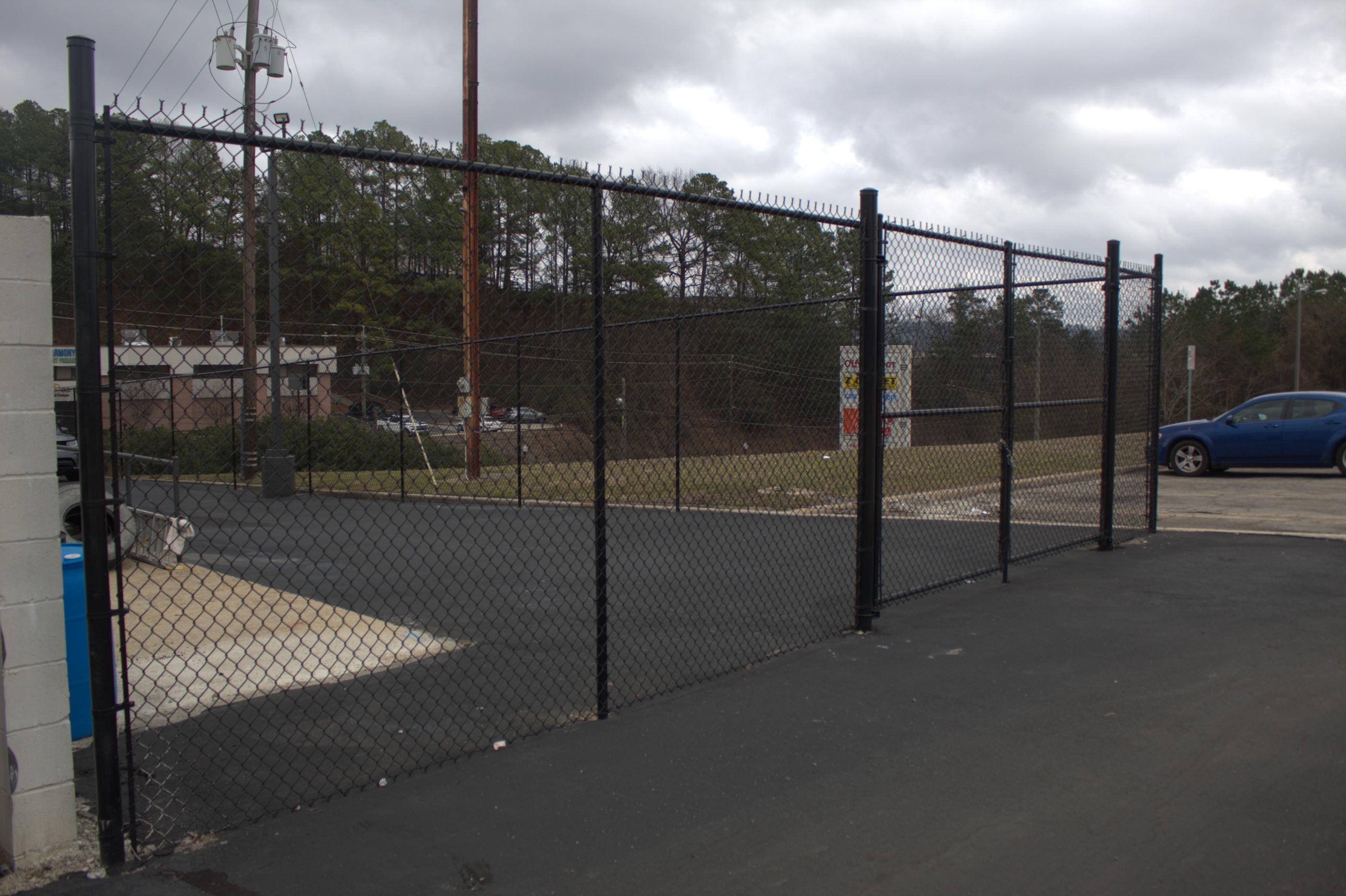 black chain link fence installed by top rail fence