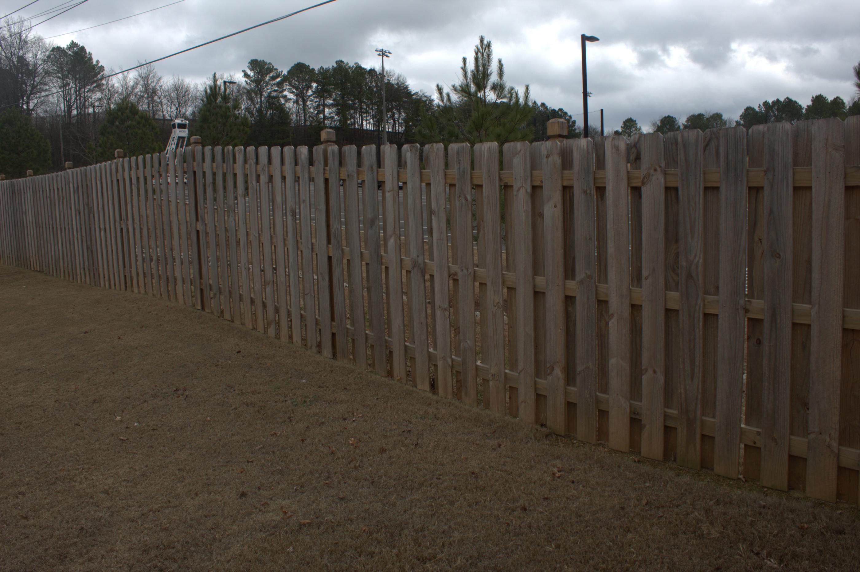wood shadowbox fence installed by top rail fence