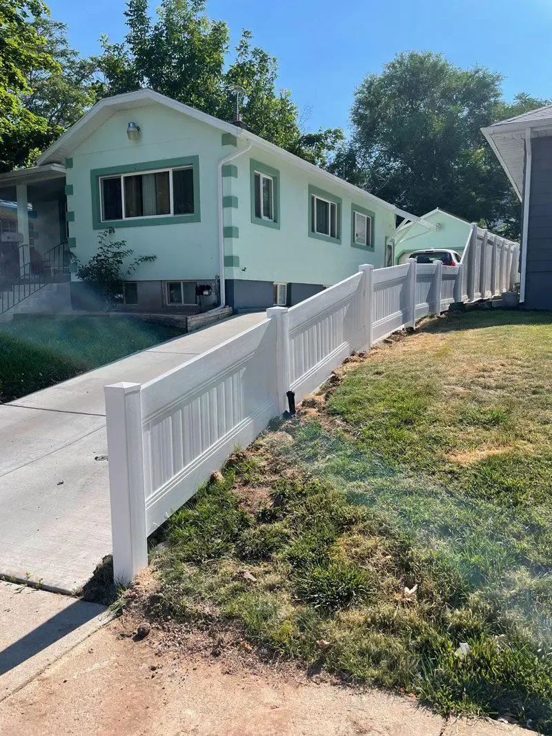 white vinyl fence installed by top rail fence