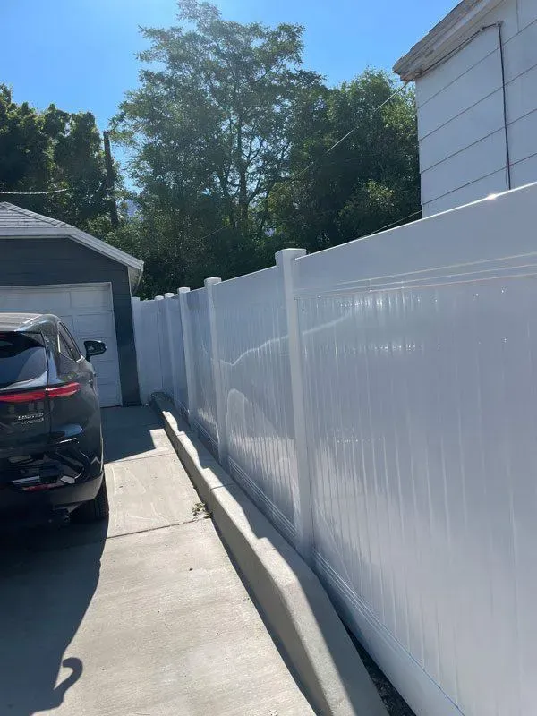 white vinyl fence installed by top rail fence