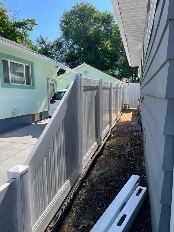 white vinyl fence installed by top rail fence