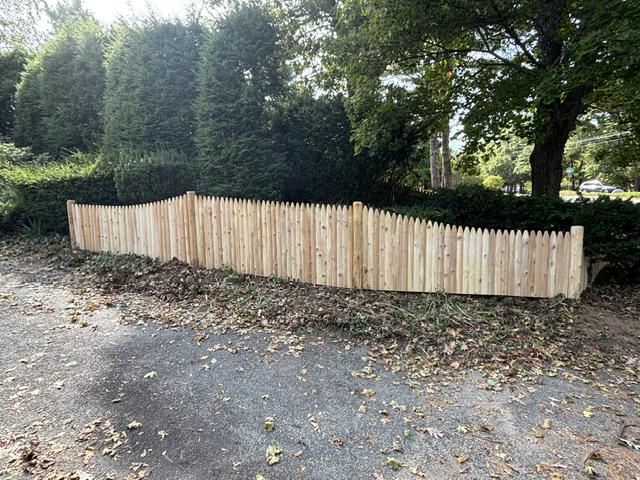 wood stockade fence installed by top rail fence