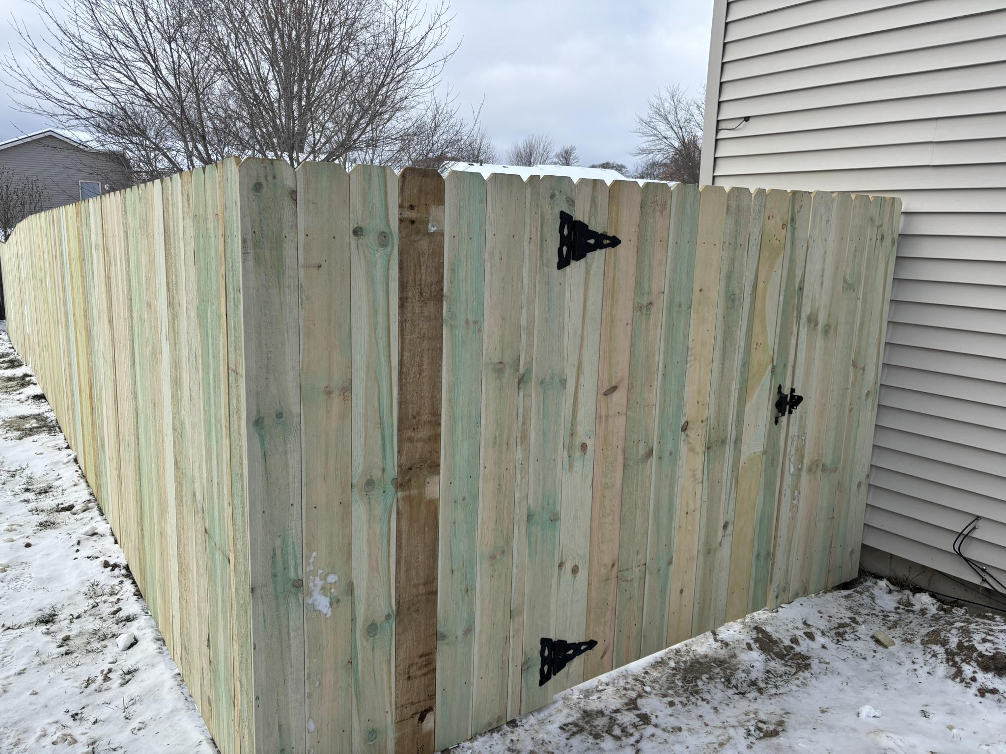 wood privacy fence installed by top rail fence