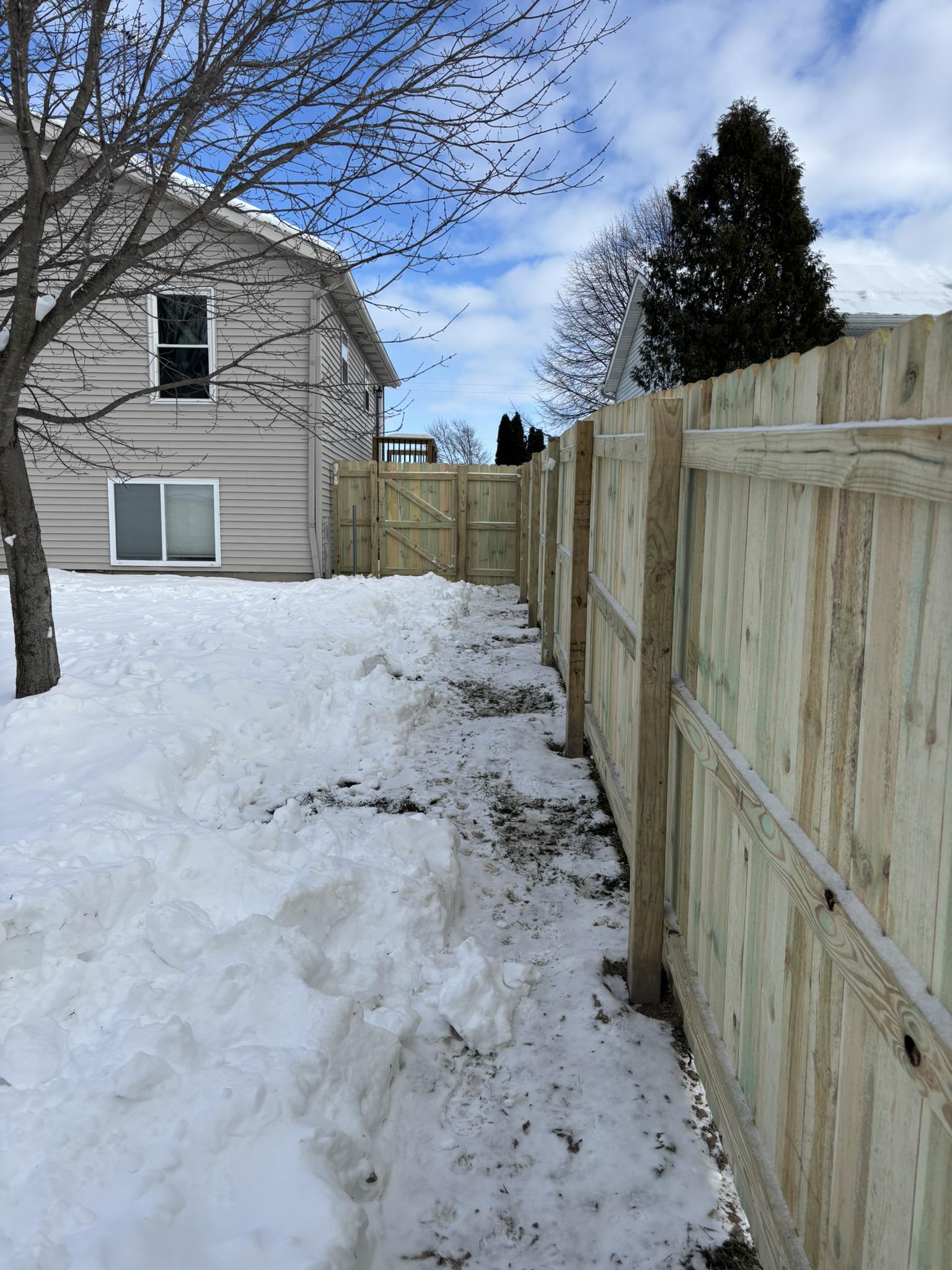 wood privacy fence installed by top rail fence