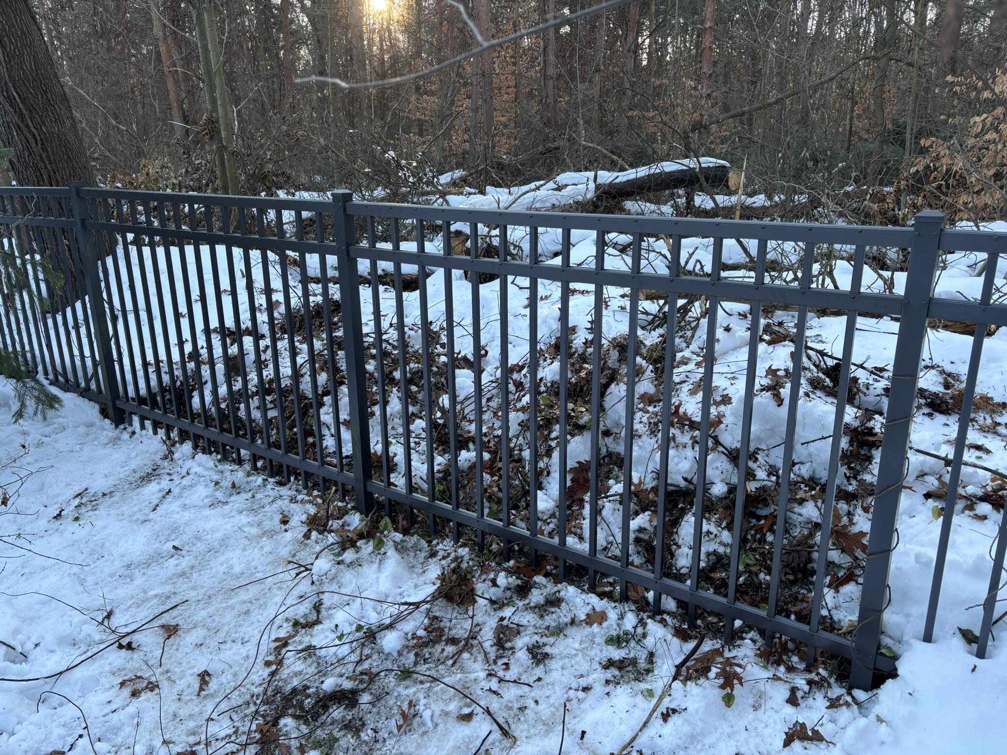 repaired ornamental metal fence by top rail fence