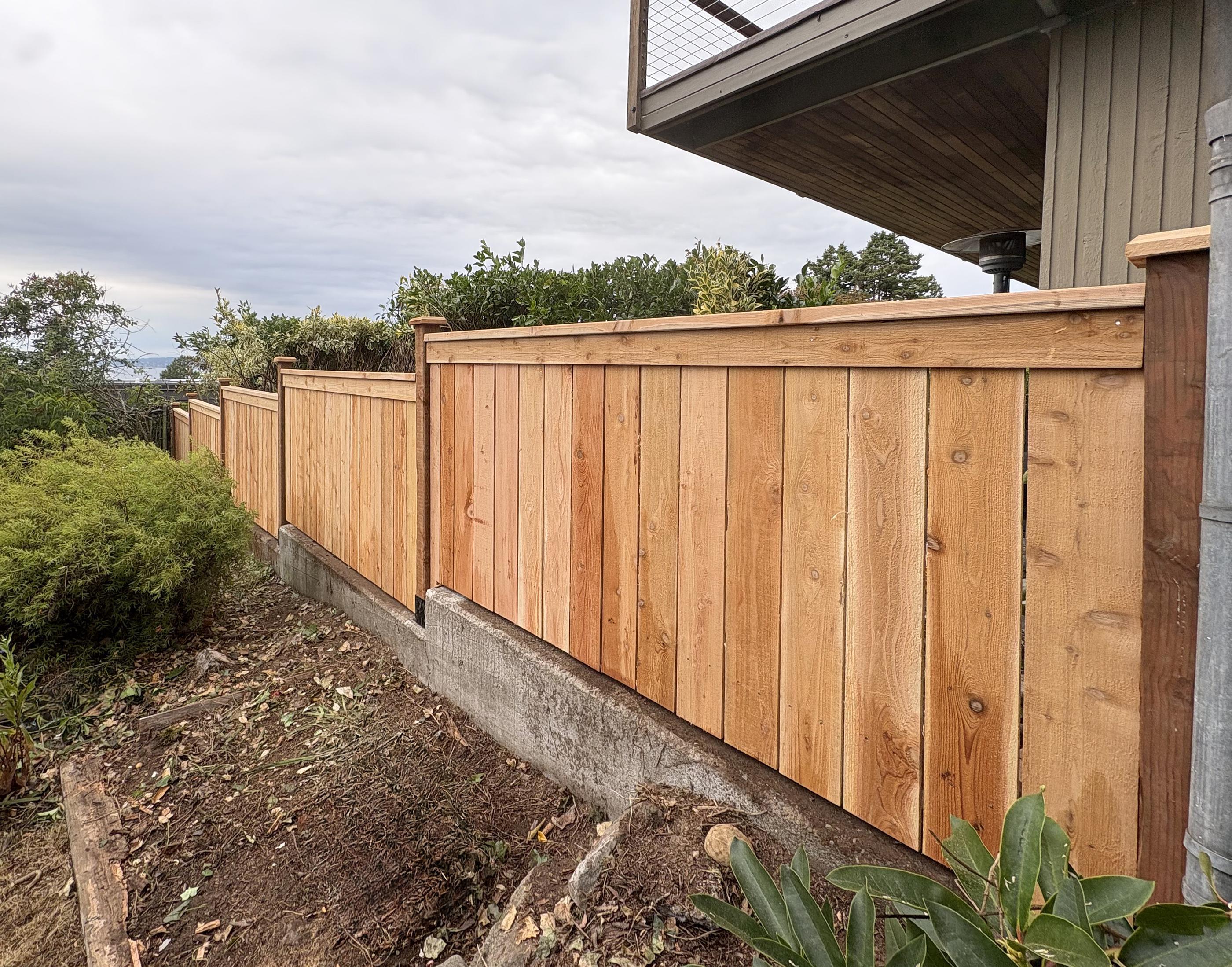 wood cap and trim fence installed by top rail fence