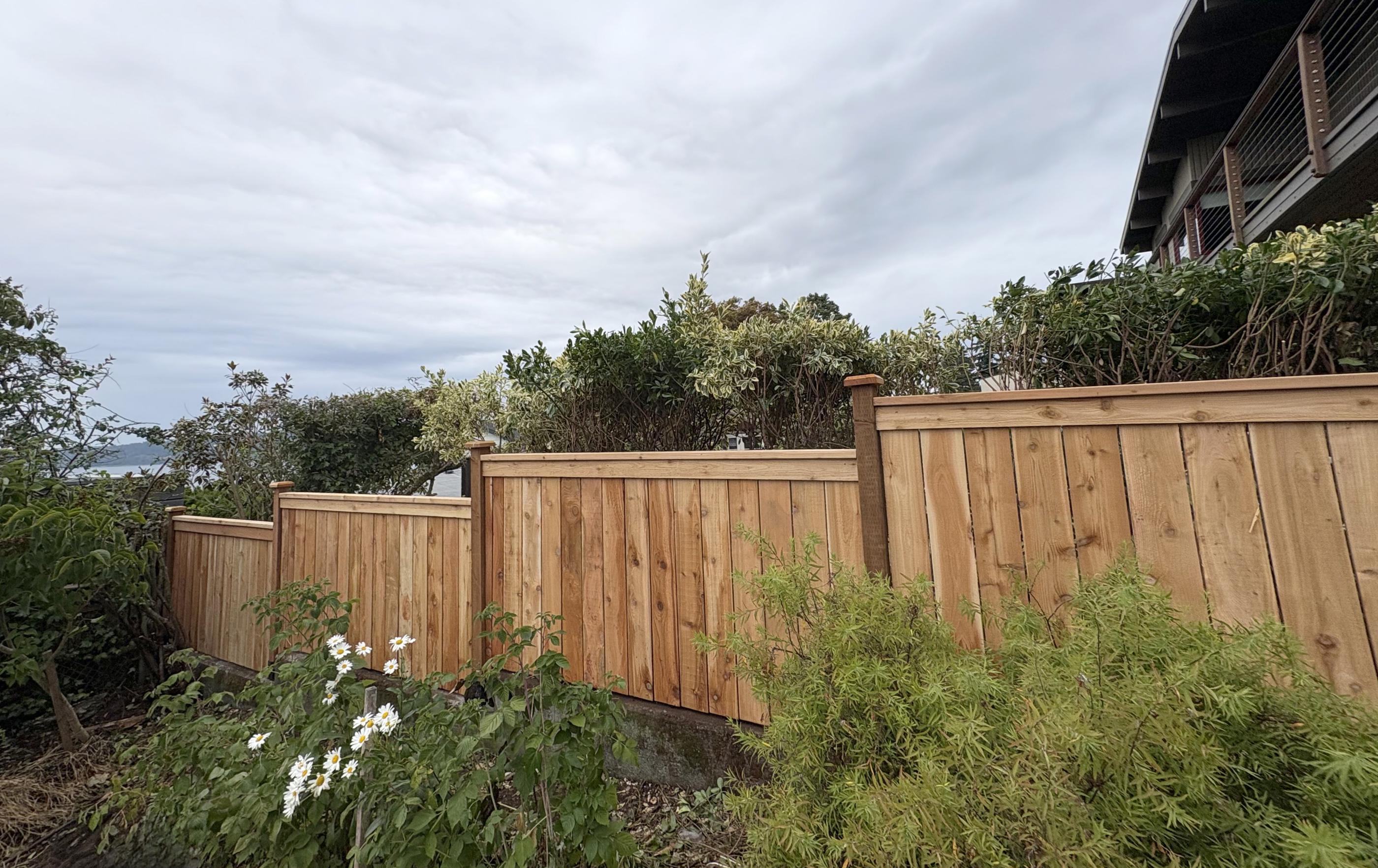 wood cap and trim fence installed by top rail fence