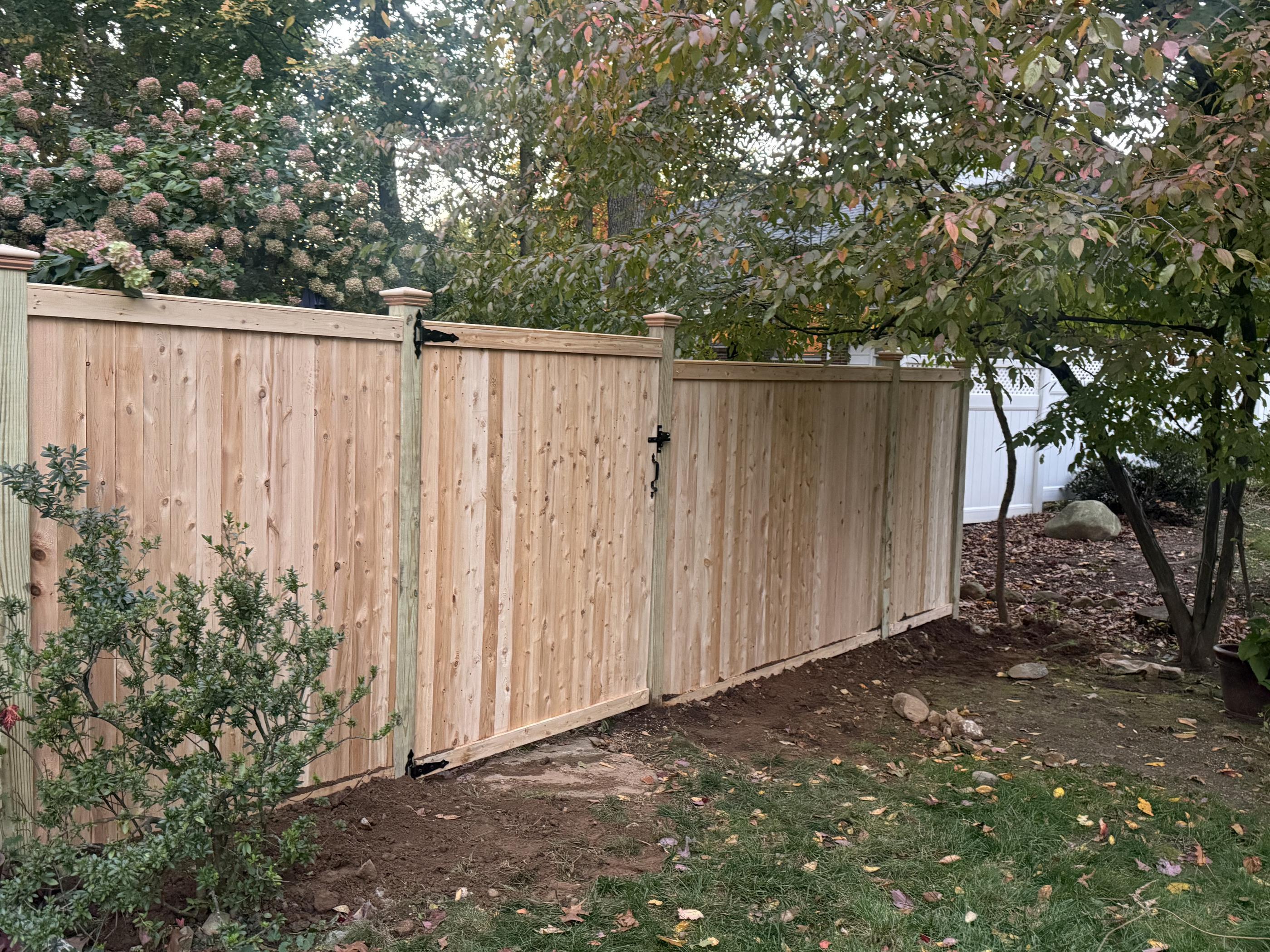 wood cap and trim fence installed by top rail fence