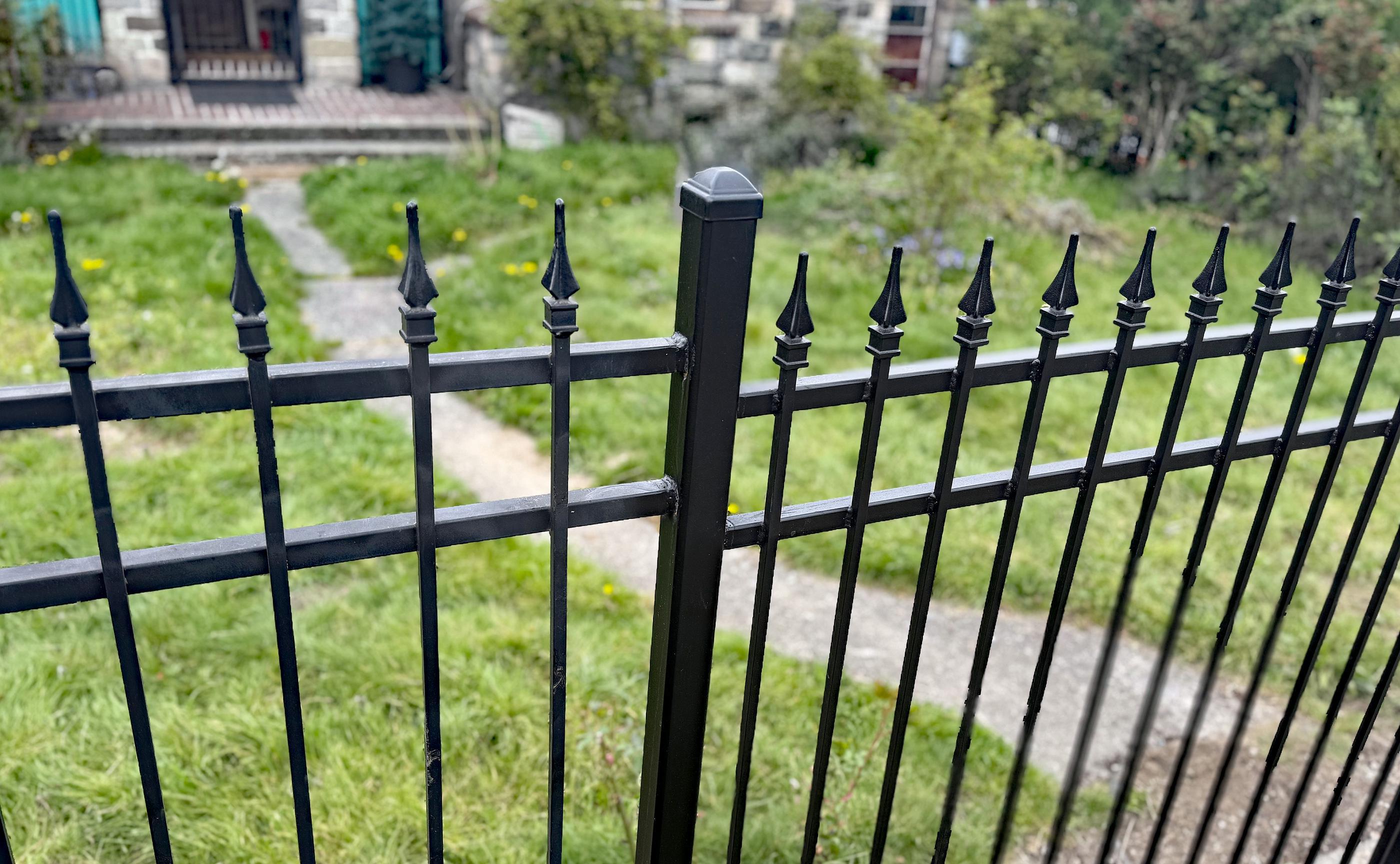 ornamental metal picket fence installed by top rail fence