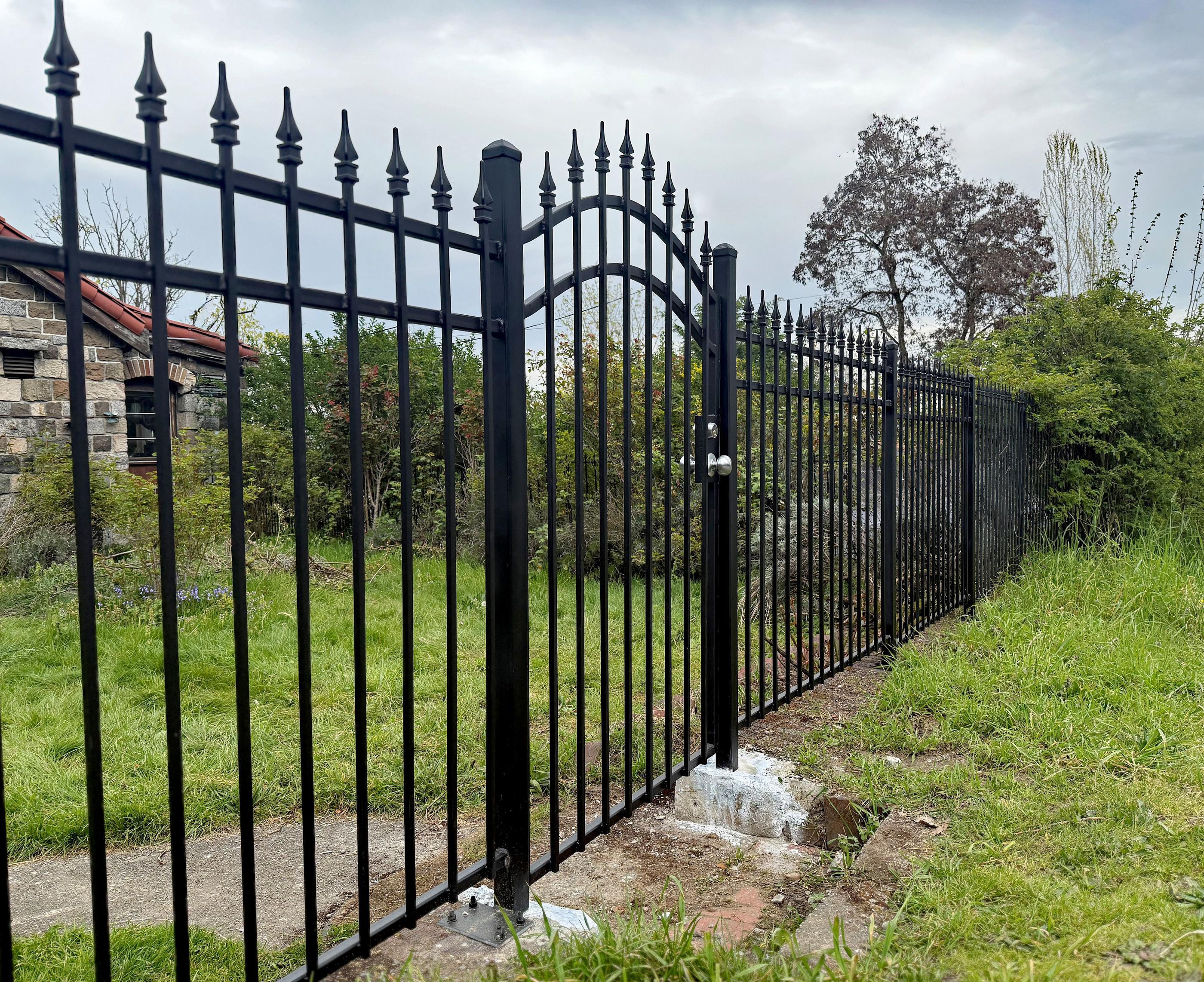 ornamental metal picket fence installed by top rail fence
