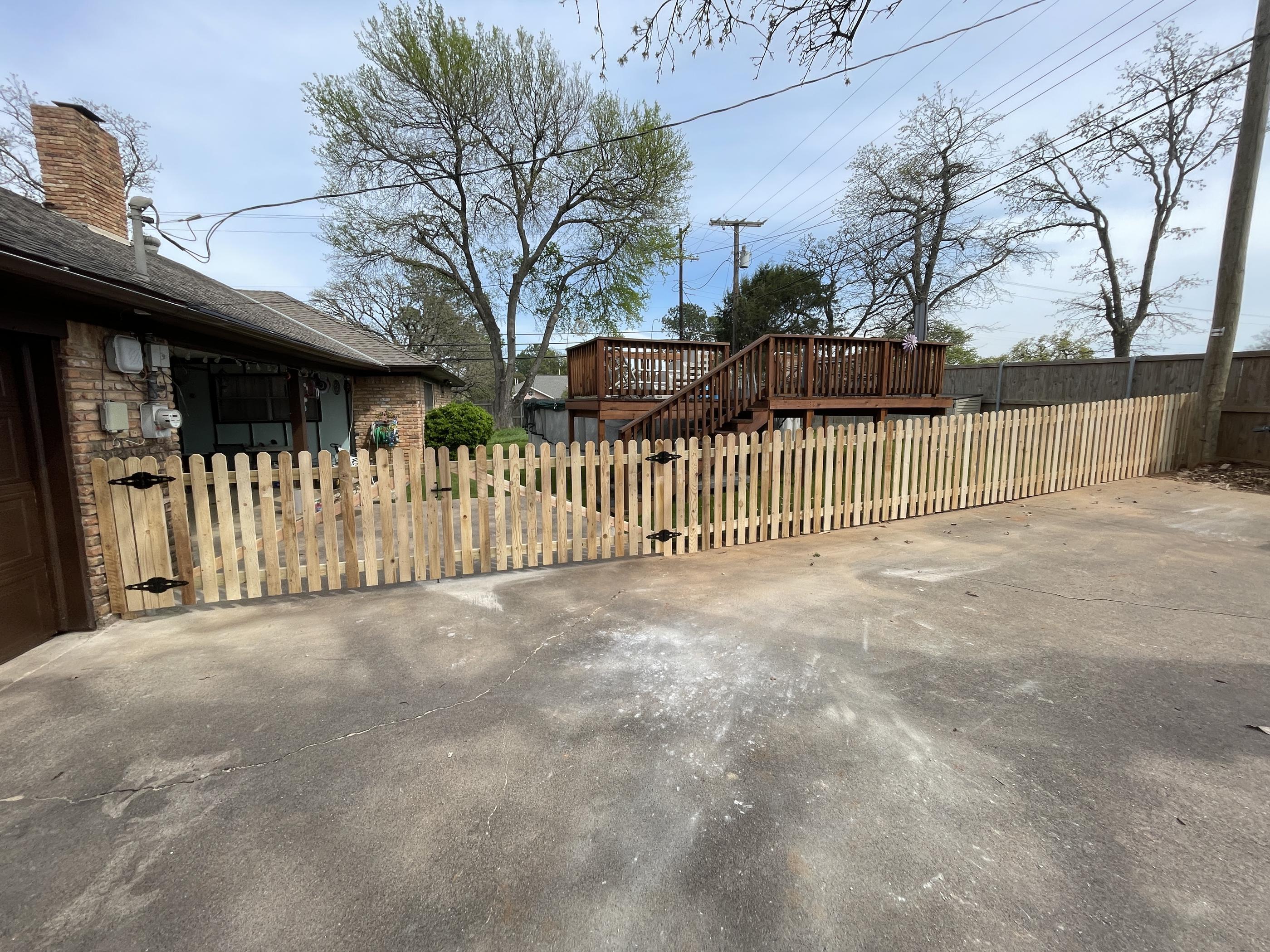 wood picket fence installed by top rail fence