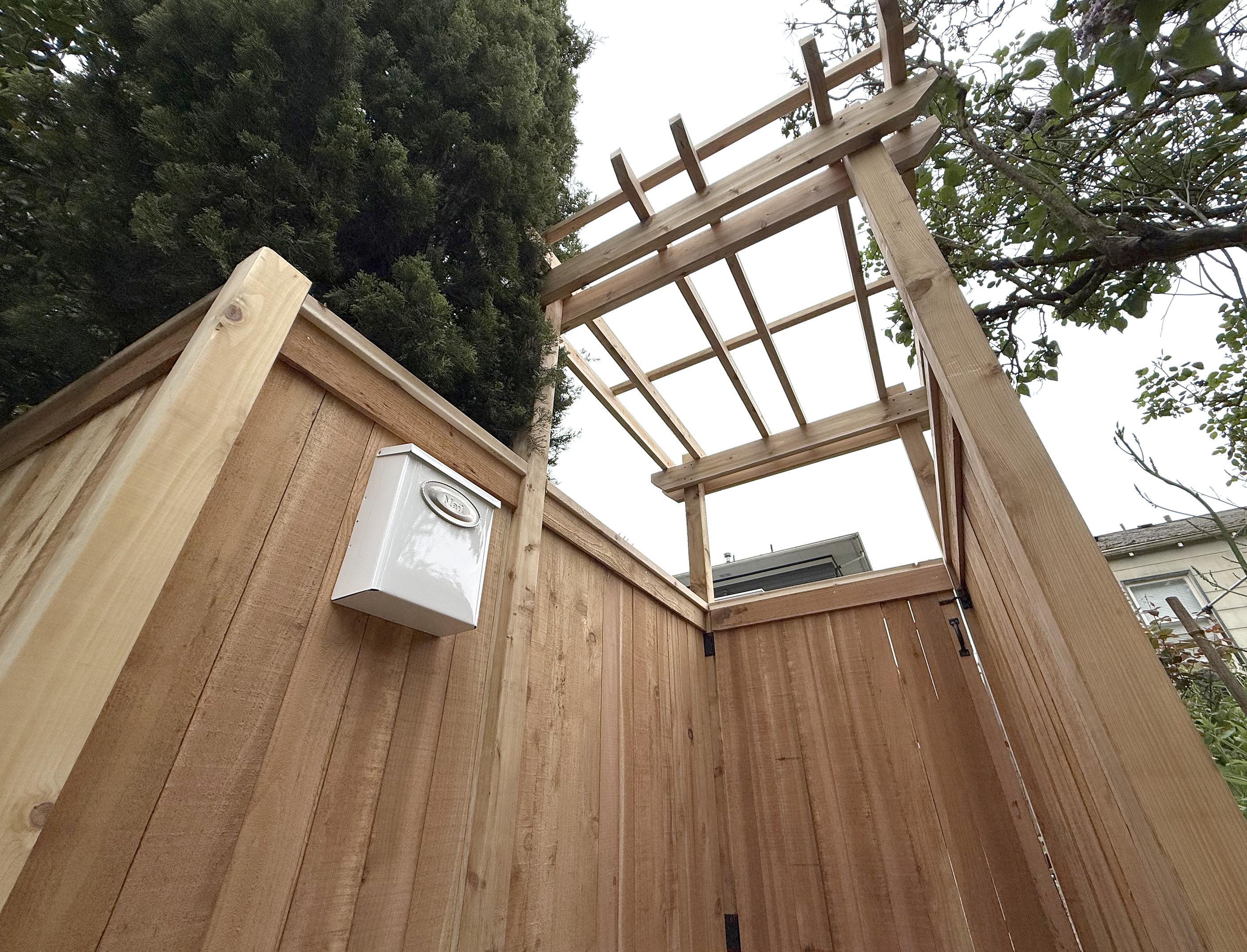 wood entry installed by top rail fence