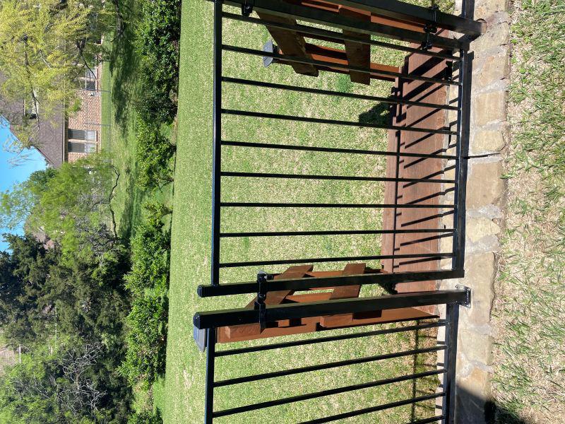 ornamental metal fence installed by top rail fence