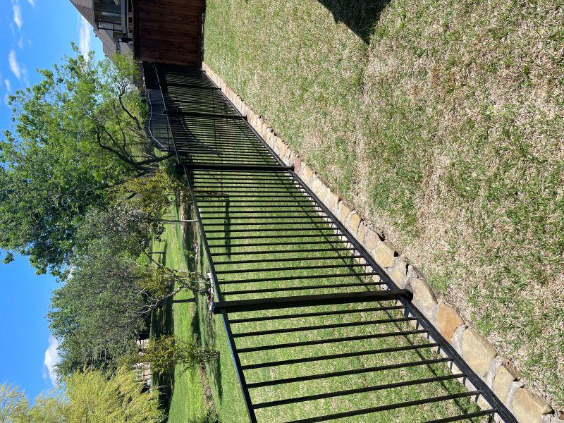 ornamental metal fence installed by top rail fence