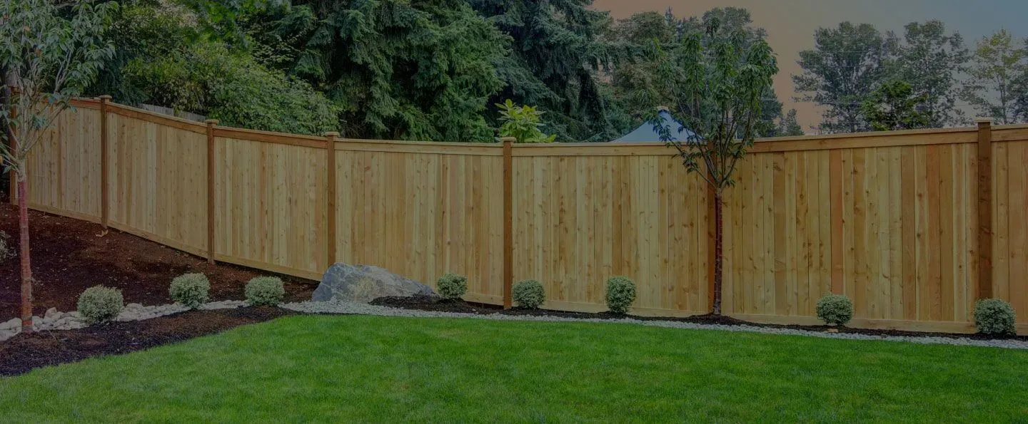 Dog standing in front of a metal fence