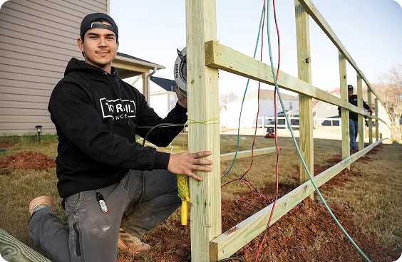A man working on a fence