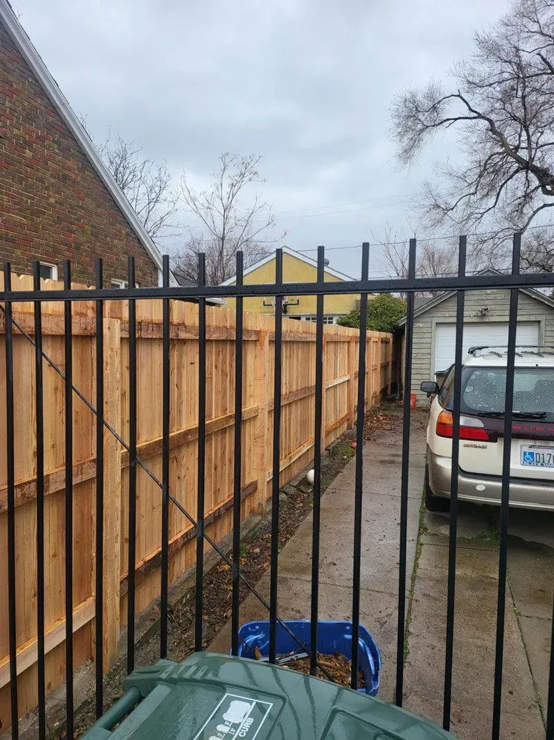 wood stockade fence installed by top rail fence