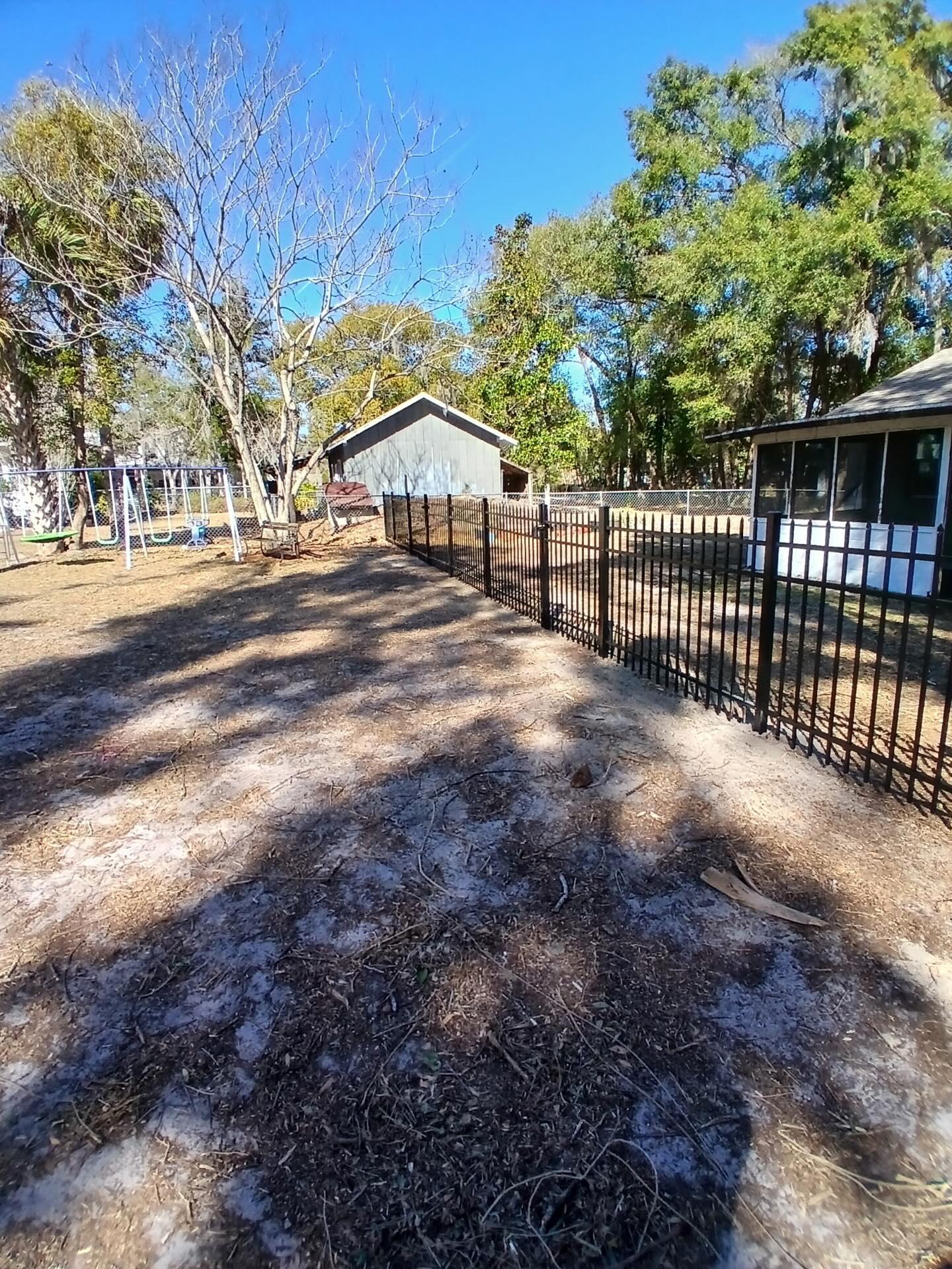 ornamental metal fence installed by top rail fence
