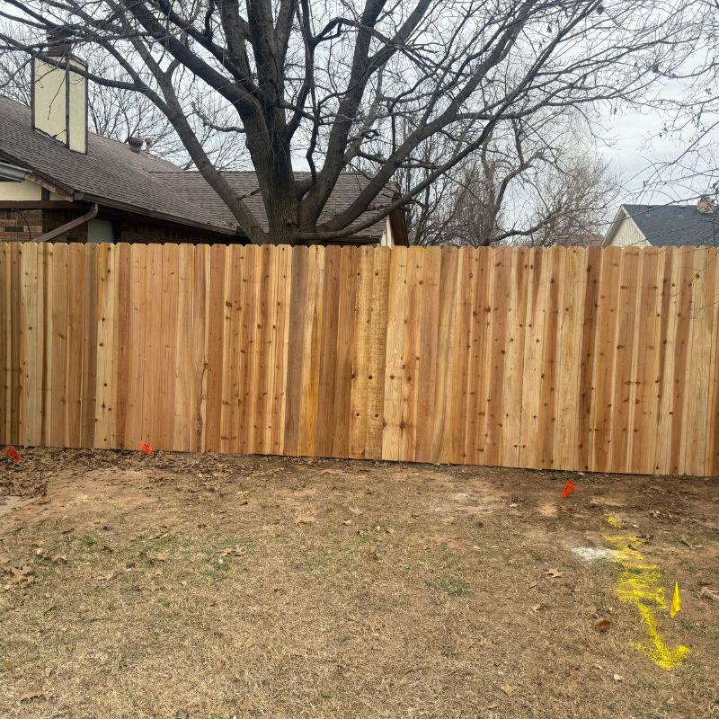 stockade fence installed by top rail fence