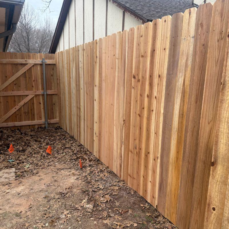 stockade fence installed by top rail fence