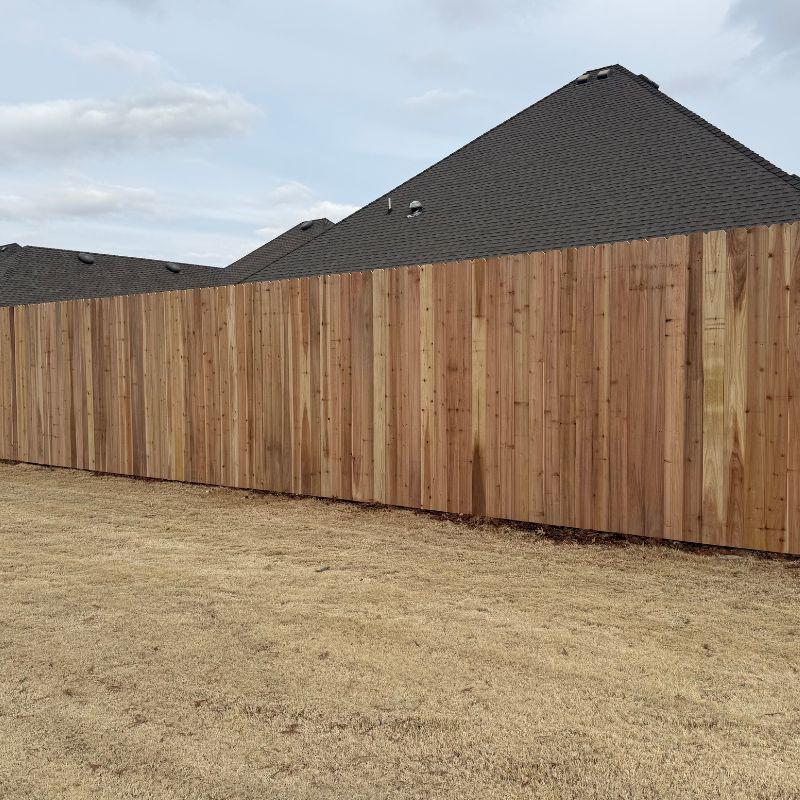 wood stockade fence installed by top rail fence
