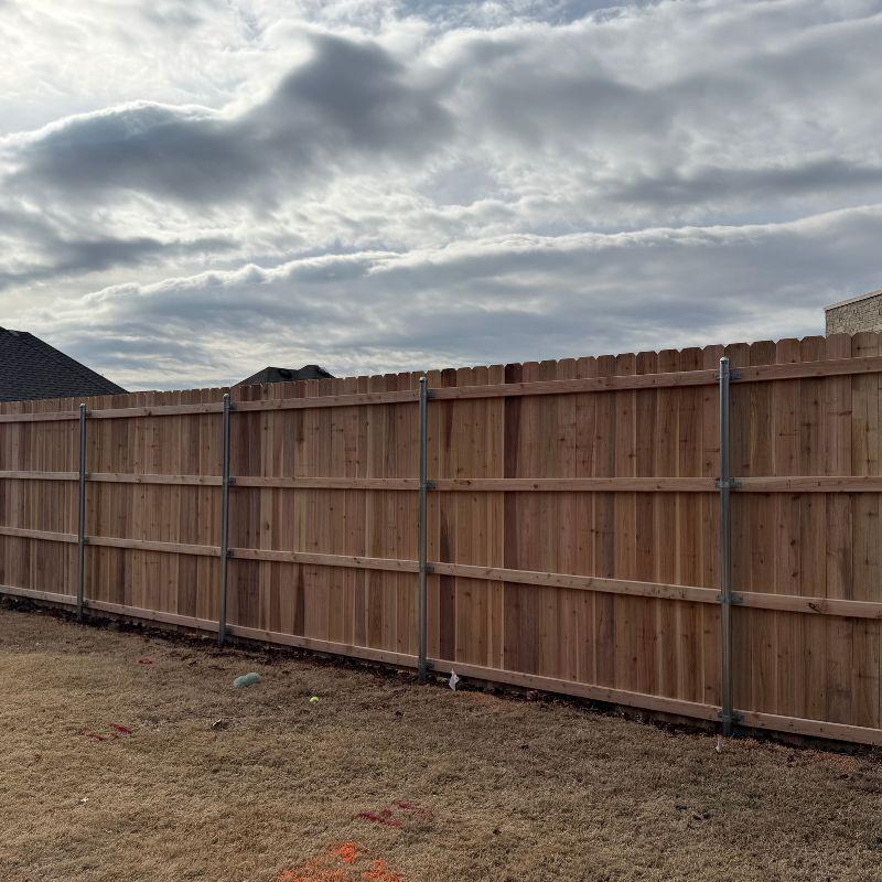 wood stockade fence installed by top rail fence