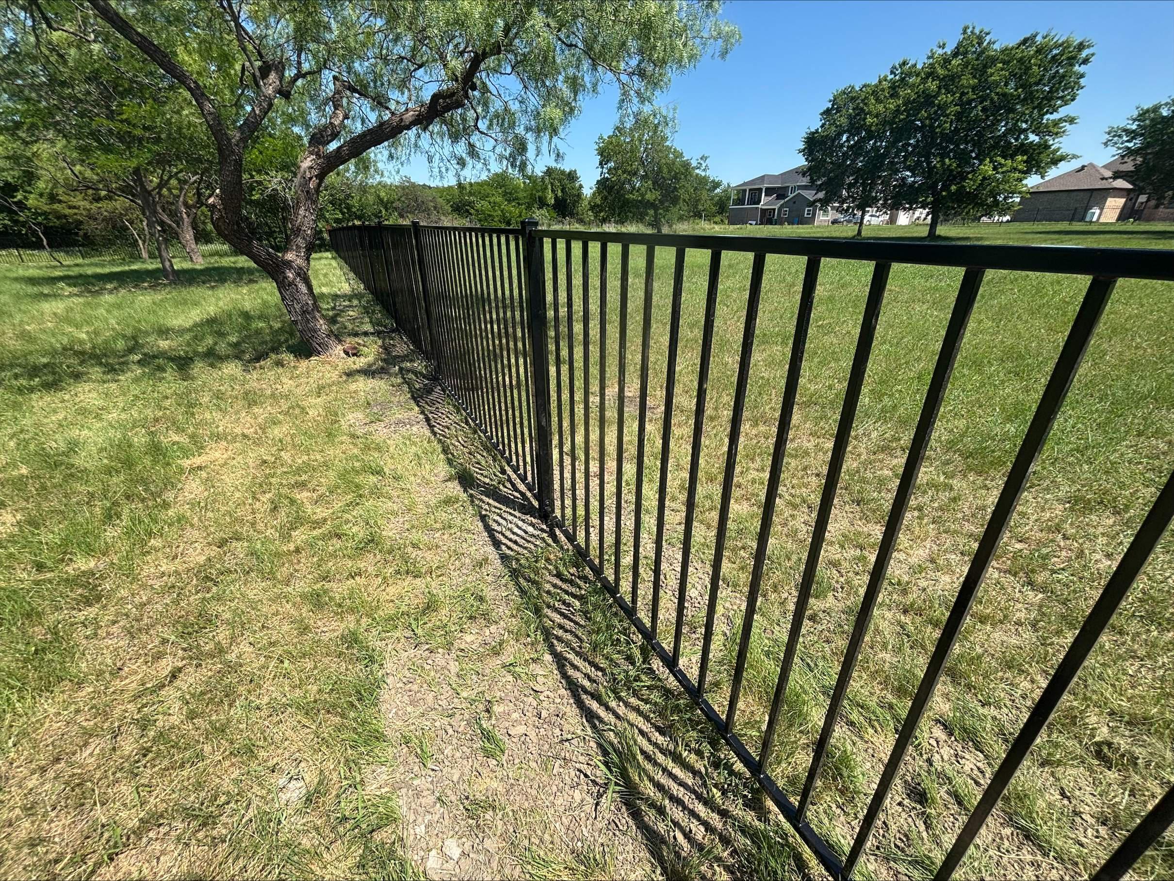  two rail ornamental metal fence installed by top rail fence