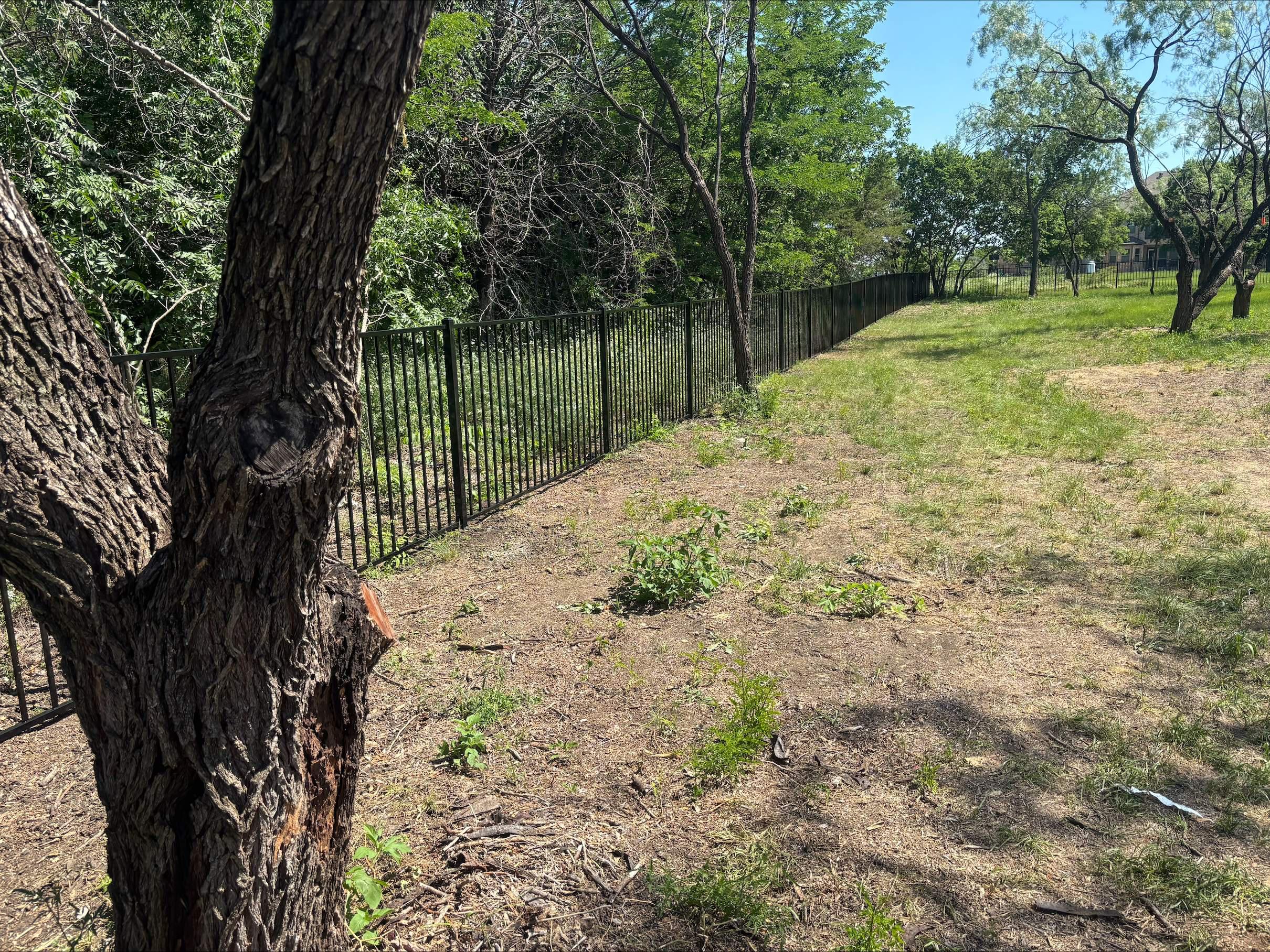  two rail ornamental metal fence installed by top rail fence