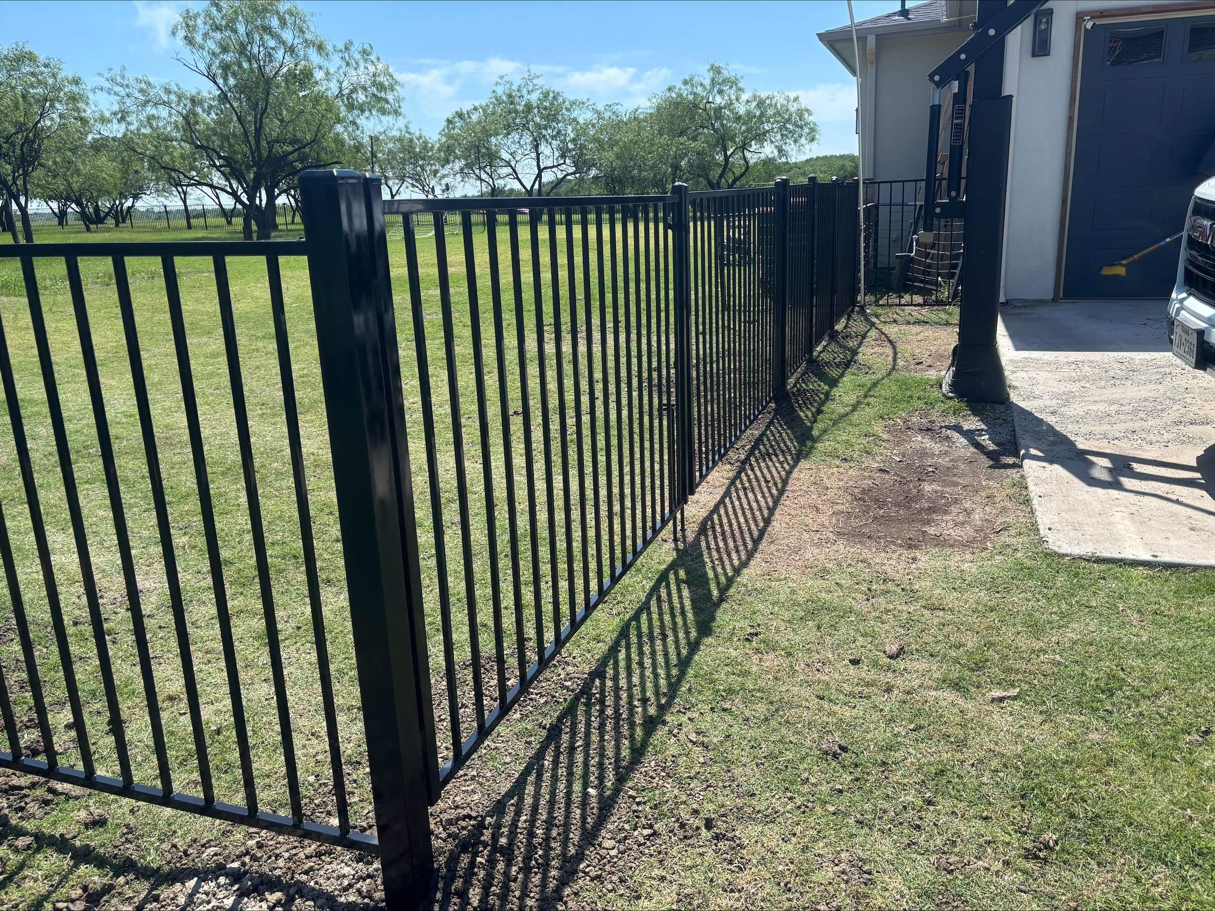  two rail ornamental metal fence installed by top rail fence