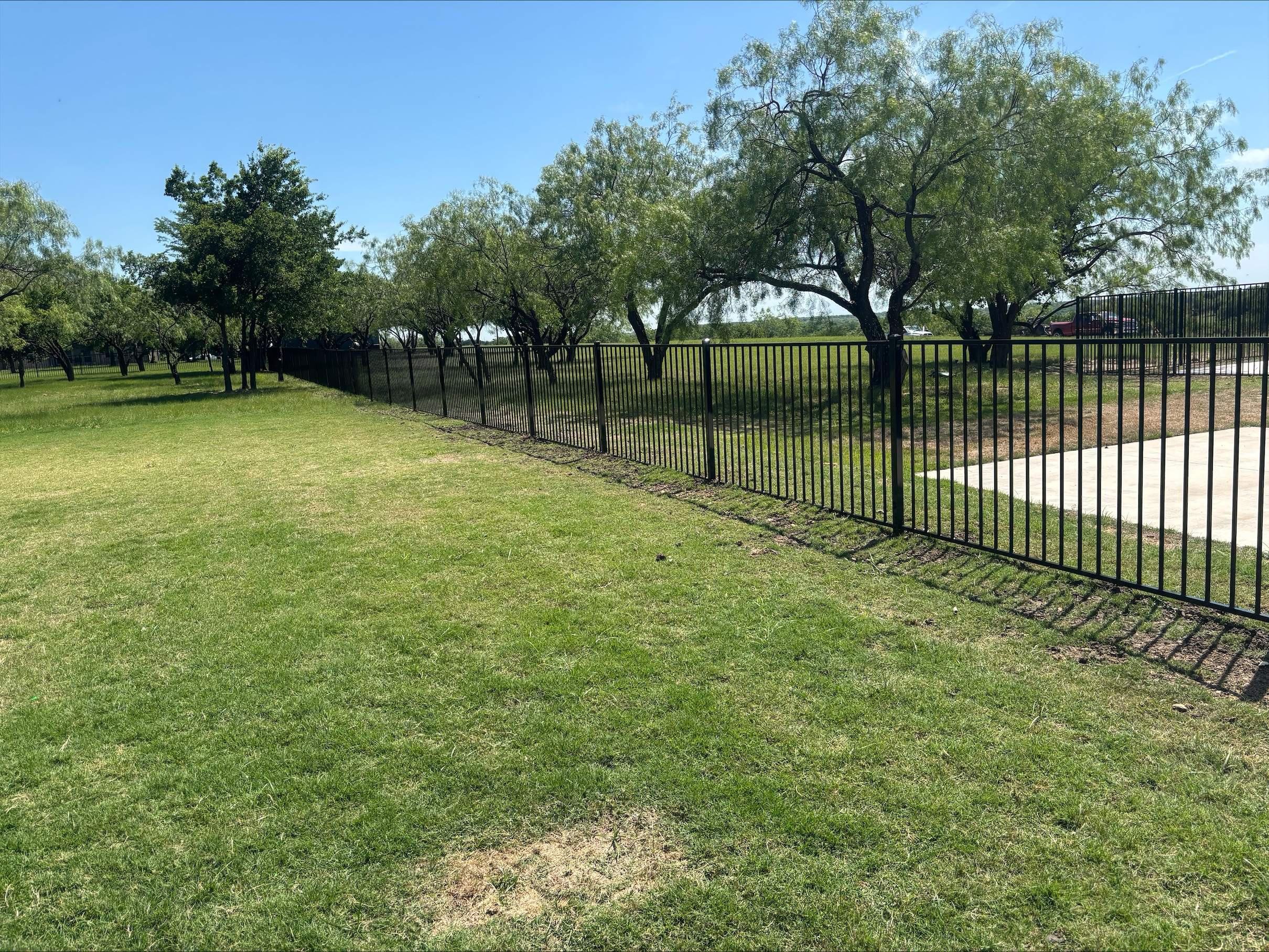  two rail ornamental metal fence installed by top rail fence