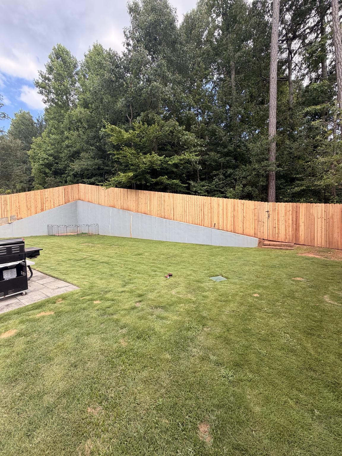 Custom Cedar Privacy Fence Along Retaining Wall