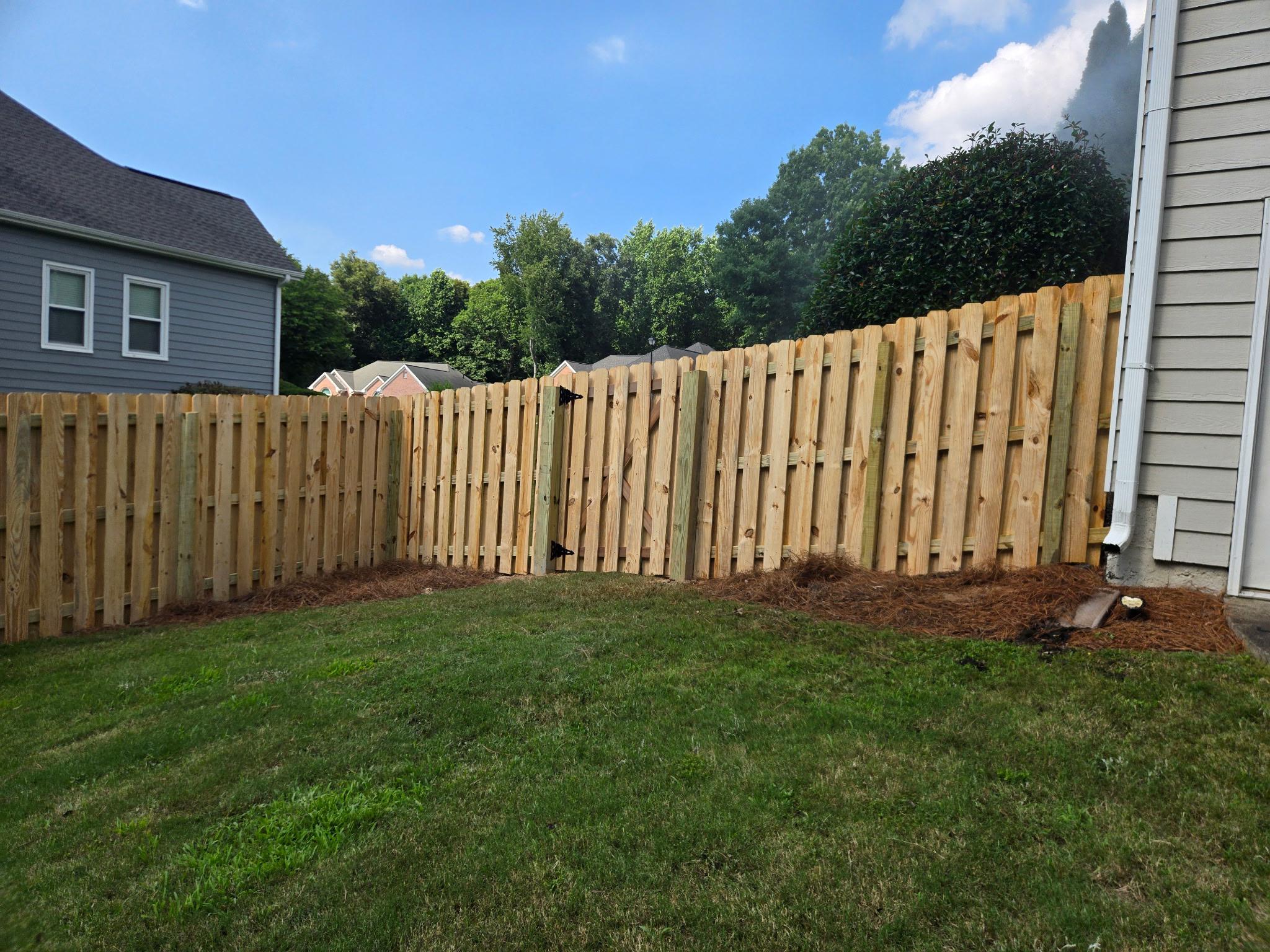 wood shadowbox fence installed by top rail fence