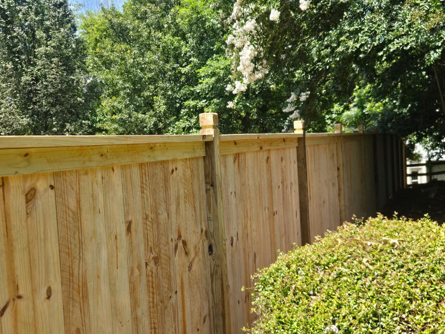 wood cap and trim fence installed by top rail fence