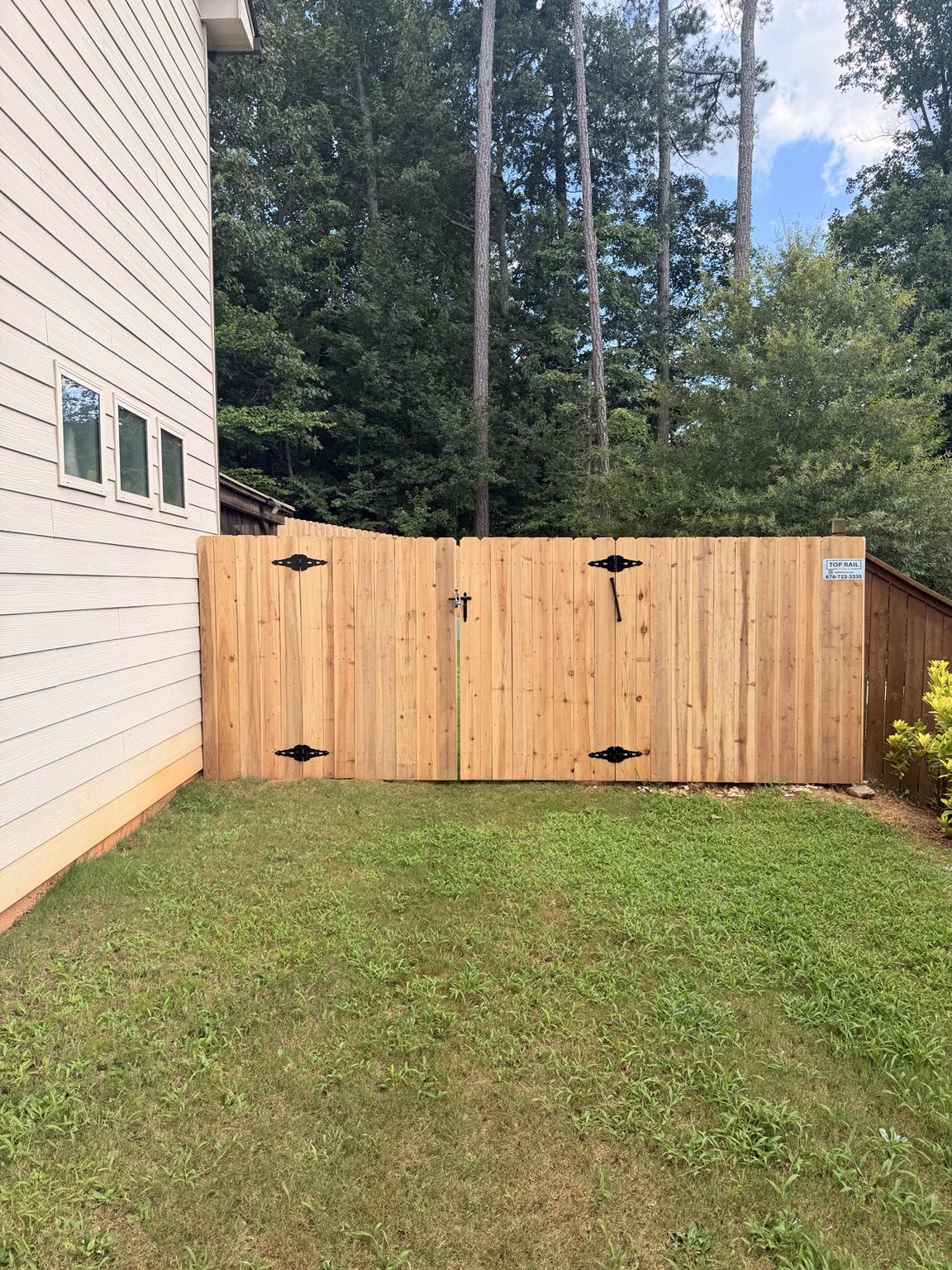 wood stockade fence installed by top rail fence