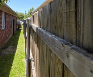 Close up of a pressure treated pine fence