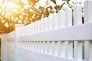 White picket fence with pointed caps