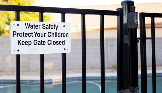 pool safety sign and code lock on pool fence