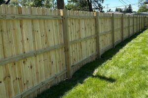 Pressure treated pine wood fence installed by Top Rail Fence