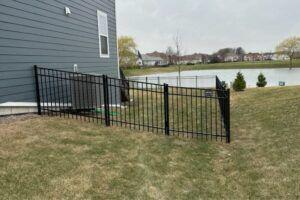 Ornamental racked metal fence on a sloped propery