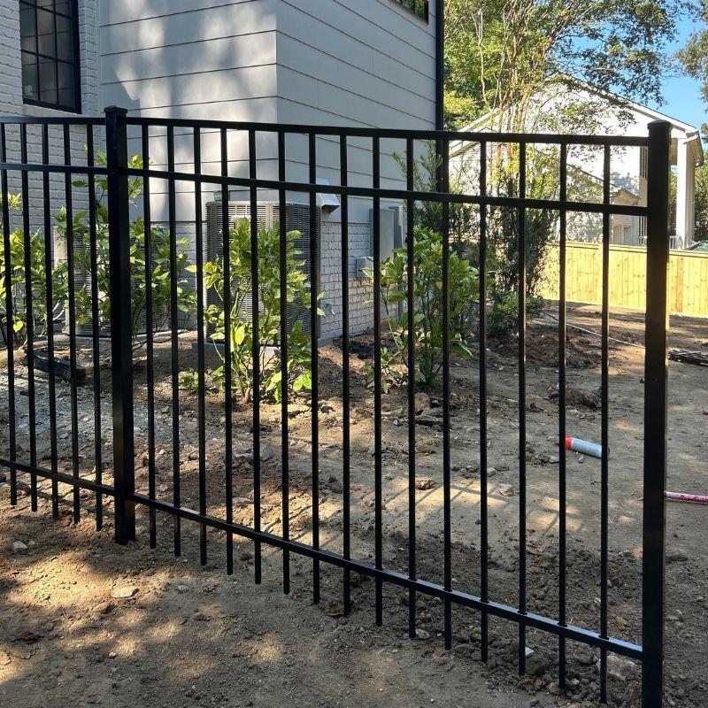 Wood and aluminum fence installed by Top Rail Fence