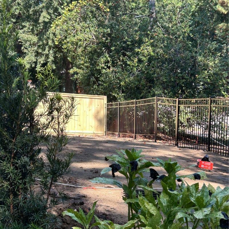 Wood and aluminum fence installed by Top Rail Fence