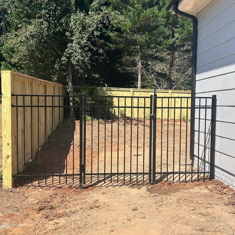 Wood and aluminum fence installed by Top Rail Fence