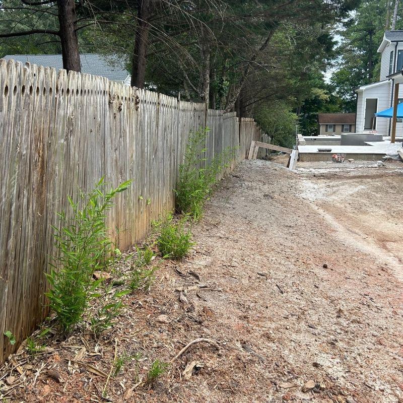 Wood and aluminum fence installed by Top Rail Fence