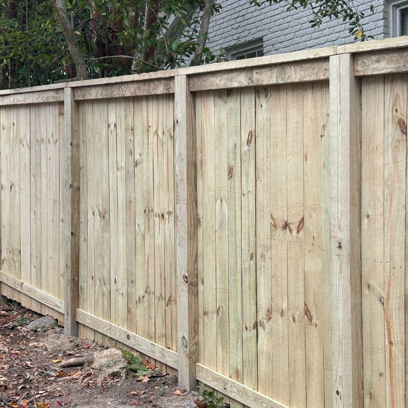 Wood and aluminum fence installed by Top Rail Fence