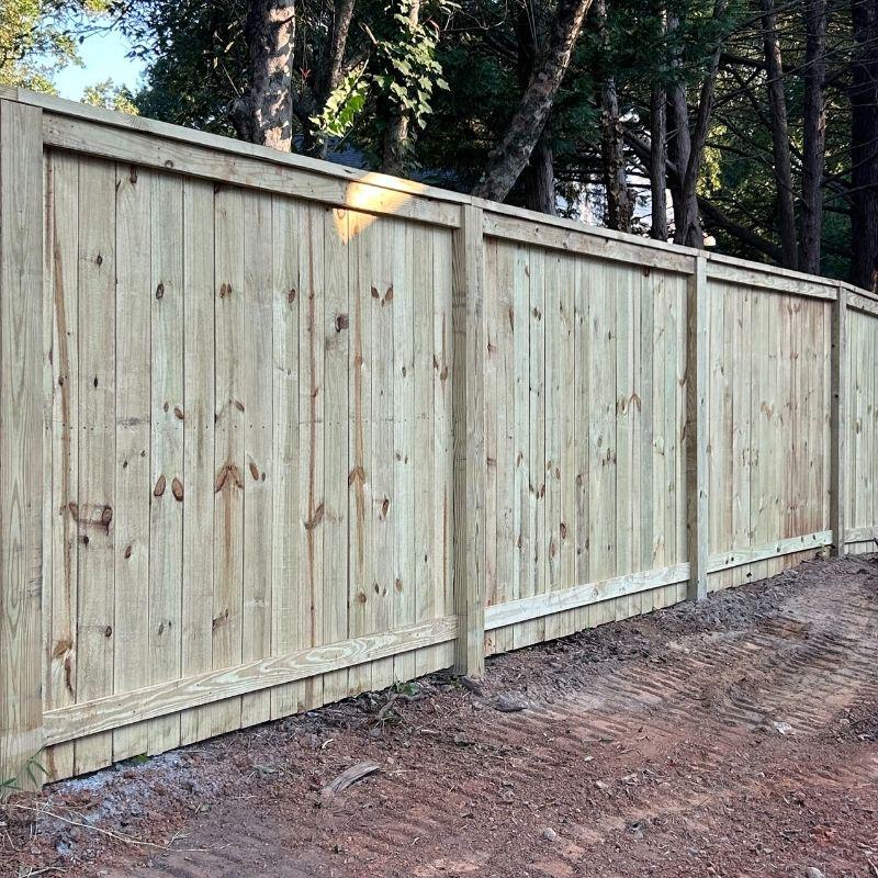 Wood and aluminum fence installed by Top Rail Fence