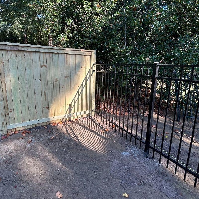 Wood and aluminum fence installed by Top Rail Fence