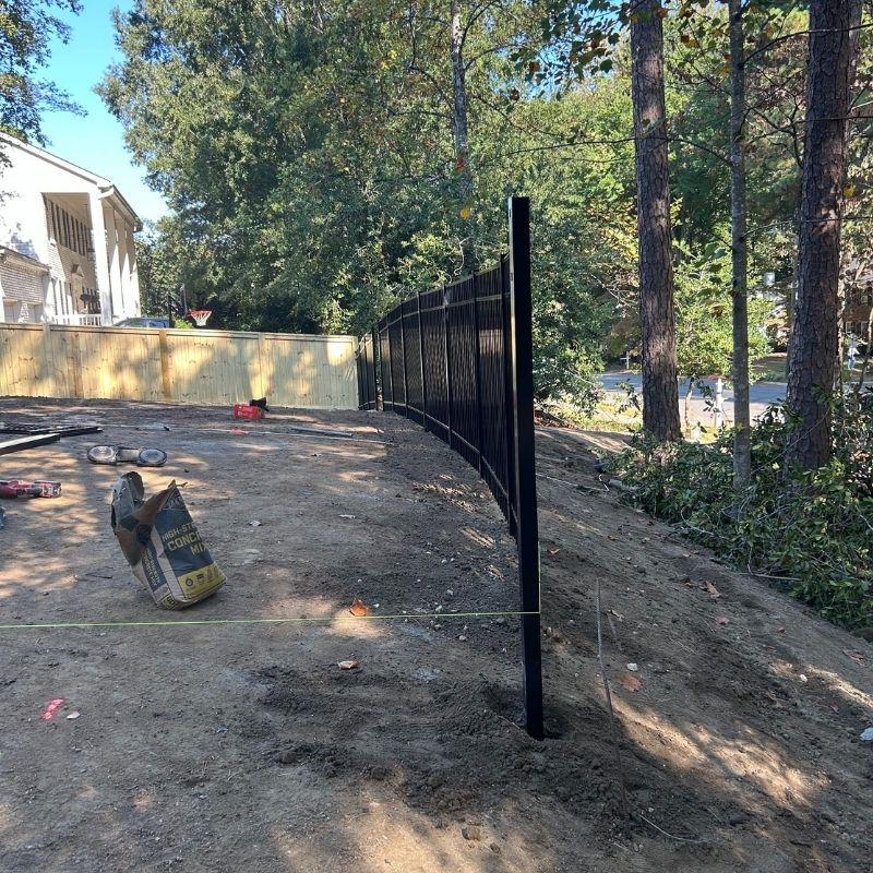 Wood and aluminum fence installed by Top Rail Fence